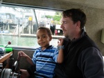Jim and Wadi pilot the boat