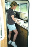 Anne can use her knee to turn water on for two handed dish washing.