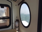 A picture of the Irish Queen taken through the iconic, round window of the Marinaut 215, Betty Ann