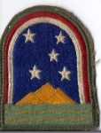 World War II Army Patch.  Not exactly related to boating, but it represents an Island that in order to travel there used to be only via water.  My great uncle served there from 1943 through 1945. It's Ascension Island. The stars represent the constellation Southern Cross. The Three Sisters mountains on the island are represented.