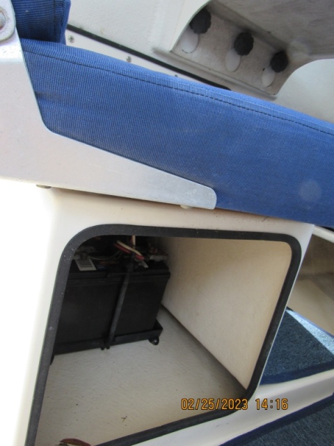 Battery in passenger seat pedestal