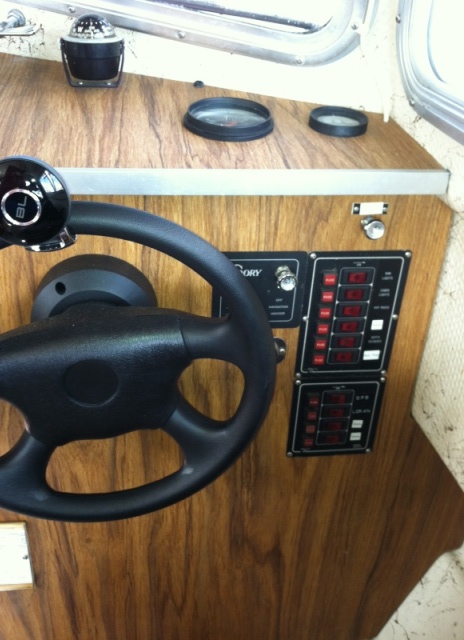 Helm with electrical panel, tach and hour meter.