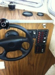 Helm with electrical panel, tach and hour meter.