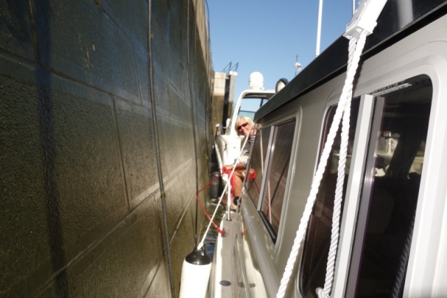 old lock walls are tapered, two feet narrower at the bottom.  Lock tenders take this into account.  You must know your boat length including protrusions like anchors