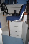 Custom cabinet and drawers under the helm seat.