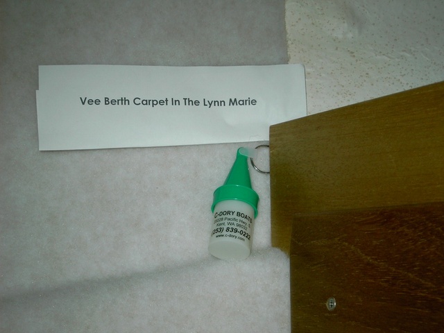 (Lynn Marie) Carpet edge at rope locker with wood trim locker bulkhead extender.
