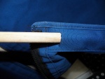 I cut a slit on the inside of the hem on the bottom to fit a piece of dowel.