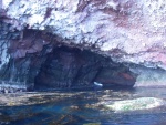 Looking into the cave that goes through. Note the rock & seaweed.