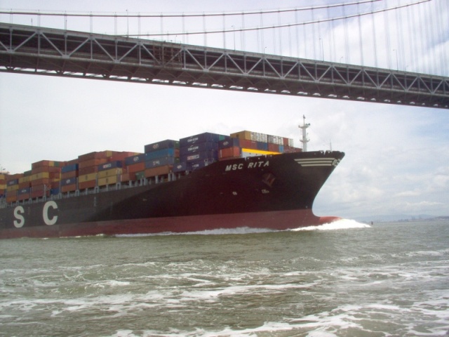 Container ship under Bay Bridge near Treasure Island