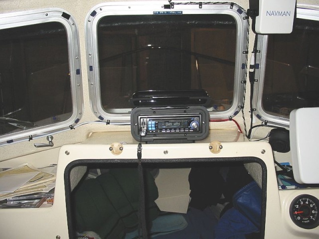 Enclosure velcroed to acrylic base. $7.00 wire Antenna(SeaWorthy Sea-Ant) bundled with speaker wires to port. Stereo is full-featured but cheap($79.88). Plays MP3s, has USB port,SD media slot, accepts I-Pod, and sports 45watts/channel