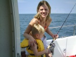 Oldest daughter nurse Beth and Grandson Tennison slapping a fish on the boat