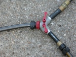 Flushing setup for use with twin HONDAs. Individual red control handles allow uniform water flow thru each engine as needed.