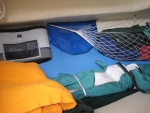 V berth area storage bags sheet bags and hamock, with foam pads on the hull side and side curtains of enclosure