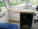 Added the 3/4 by 3/4 wood strips on the dash area.  Also some teak grabs for the 1st mate.   July 2010