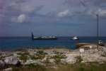 Hunky Dory traveled from Tampa to Grand Cayman on a cargo ship, then from Grand Cayman to Little Cayman on the weekly barge that is pulled by a tugboat.  This is our first peek at her, sitting regally on the barge.