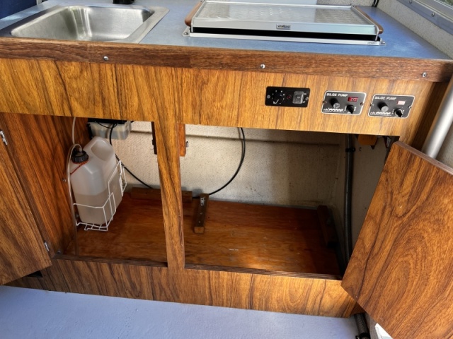 Storage, Wallas Fuel Supply Far Left and Bennett Trim Tab Controls and Reservoir Upper Left Under Counter - ProMariner ProSport Battery Charger Upper Right Under Counter