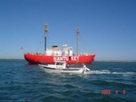 A winning photo showing INN THE WATER along side of the NANTUCKET LIGHT SHIP.