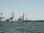 The old and the new.  A schooner returning from the great Schooner Race - Annapolis to Portsmouth Va. and DDG 51's at Norfolk Naval Base