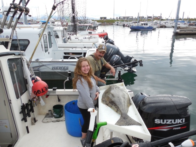 My 12 year old niece with her first halibut (65#)