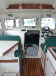 I got tired of things falling off the overhead shelf when the boat starts bouncing.  I wanted to close it off without taking away any accessibility and useability of the full shelf width.  Simply turn both spring loaded latches and the door swings down offering full access.  Made it out of sapele finished with oil.  Matches the teak fairly well.