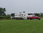 Boat and Truck Parked Alongside Fifth Wheel Trailer