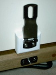 Stainless steel hasp with the TyBoo gizmo below. The threaded female section is for the knob that locks chair in place.