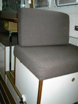 Barber chair on the Lynn Marie in the inovative TyBoo position. Cushion snaps onto bottom of table.
