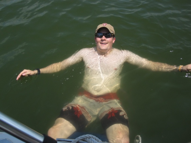 Son-in-law J enjoying very warm water in PK while sitting on a fender.