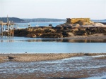 One of the many obstructions in the harbor, notice the high tide line on the rocks (12 Ft).