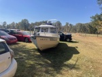 a month in a wet field waiting for the adjuster to make a call - he couldn\'t inspect it without lifting... so they totaled the boat