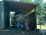 Three of my grandkids in front of the boat shed.