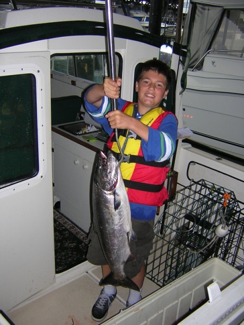 July 18th.  Mason is holding the fish that he netted but it fell through the net.  Turned out the metal ring at the bottom of the net had broken and many of the loops were off.