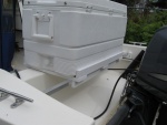 Cooler and rack, secured with bungee cords off handles to SS clips in splash well