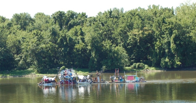 Miss Rockaway (dumpster diver raft, 2 VW diesels, and about 20 hippies), on the way to St. Louis, MO. on Old Man River. It's 80 feet long. Google up 