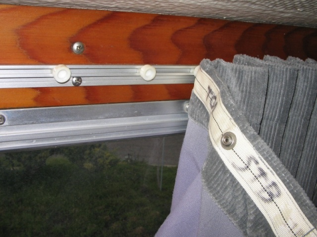 Sliding curtains, detail of track, plastic cars, and fabric tape with snaps,(all made by Recmar) sewed to curtain material.