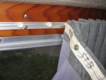 Sliding curtains, detail of track, plastic cars, and fabric tape with snaps,(all made by Recmar) sewed to curtain material.