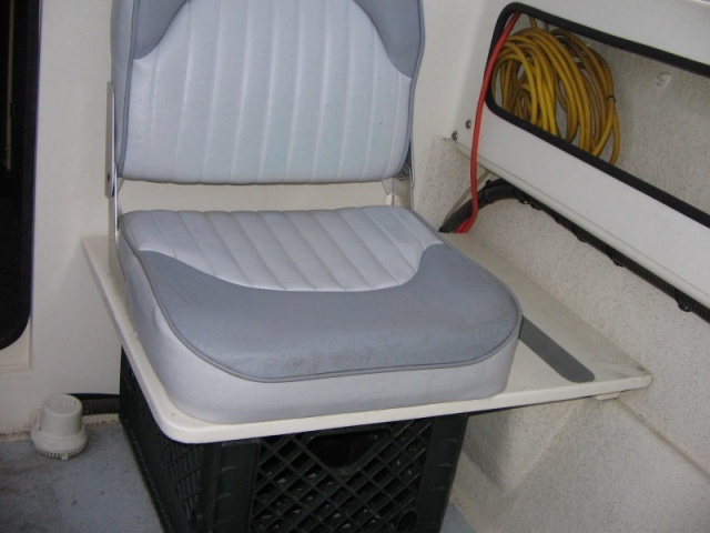 Cockpit seat with 'puddle sucker' bilge pump.