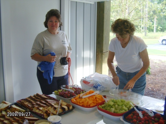 Jackie and Sandra helping setup fruit