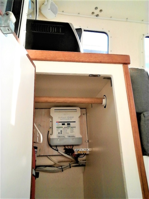 Mounting a state of the art ProNautic 1220P Charger high in hanging closet makes monitoring easy and out of the way of original under seat storage area