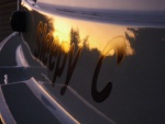 Sunset Reflection on the SleepyC port side name plate.