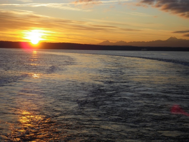 Sunset off the fantail of the Kingston ferry, with the Olympic mountians in the winter sunset.