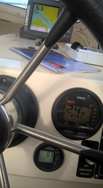  2400 rpm gives a SOG of 6.2 knots at .7 gallons per hour (supposedly 10 mpg, although I usually only get 8).  At WOT I have seen it go as high as 3.6 gph. 
 Yes, I'm only in 5.3 feet of water, but I'm heading out of the little bay right in front of my cabin.  It's cool.