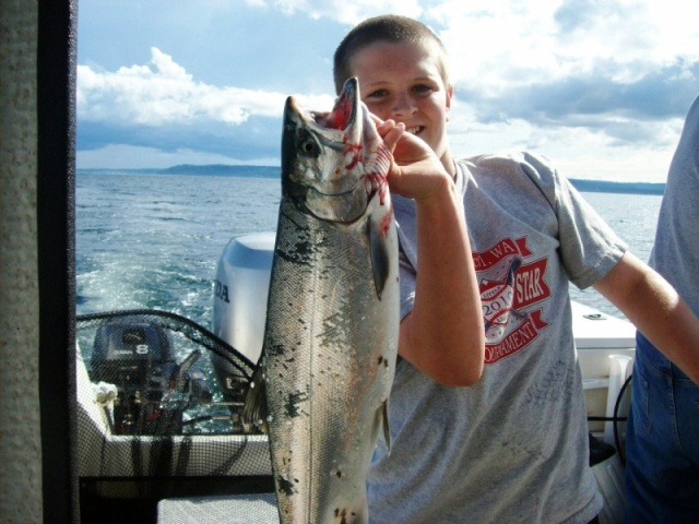 Possession Coho.  Caught 55' down on chartruse hootchie.  Not a bad bonus on top of the kings. 7/16/2011