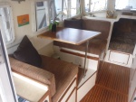 Port side w/ new table to compliment flooring, woodwork & new upholstery.