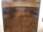 V-berth with custom memory foam matress & bedding, hypervent under matress, walls insulated with closed cell foam & lined with tan carpet/headliner. 