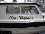 (Sea Skipper) Carabineers are attached to pre adjusted fender whips and are in turn clipped to eye loops above rub rail - one showing below name.