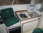 (Sea Skipper) Galley unit  Wallas stove located toward front of cabinet leaves space for microwave behind.  Microwave raised 1