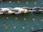 Chain/Rope Splice: Ends of two strands are sewn toigether and whipped/fused with heat.  Butt end is pulled down into space beweeen links after tension is applied.