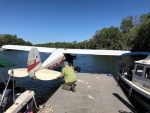 Colby helping the float plane off the dock.