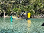 Airboat with kid spearfishing on front in Silver Glen Springs